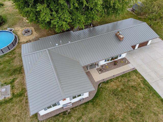 Second aerial view of the same house, showing the roof and the driveway